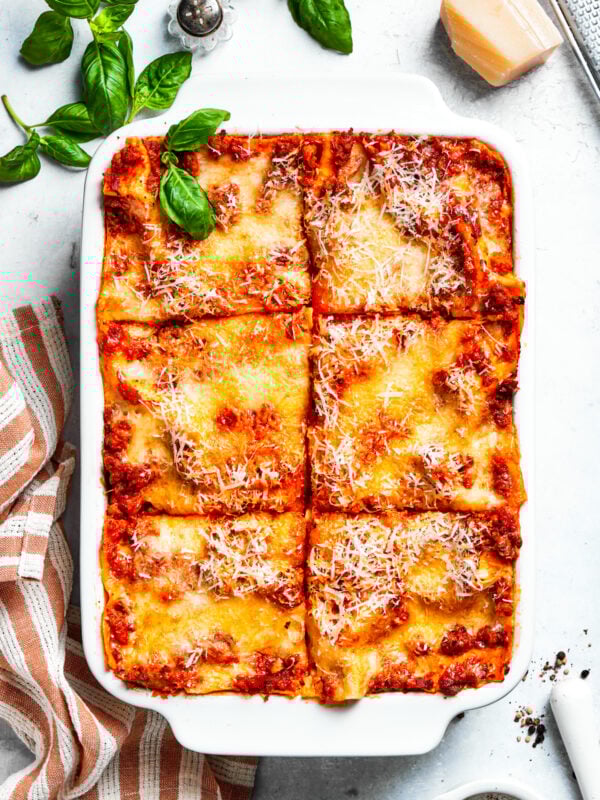 A pan of beef lasagna cut into squares.