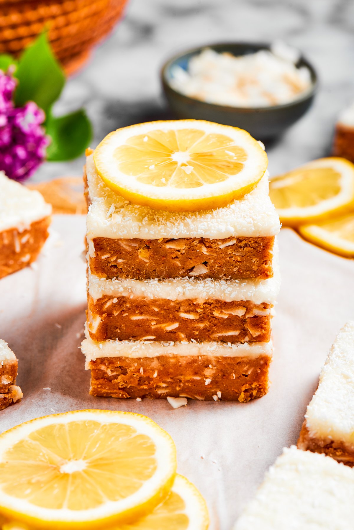 A stack of lemon slice squares garnished a lemon.