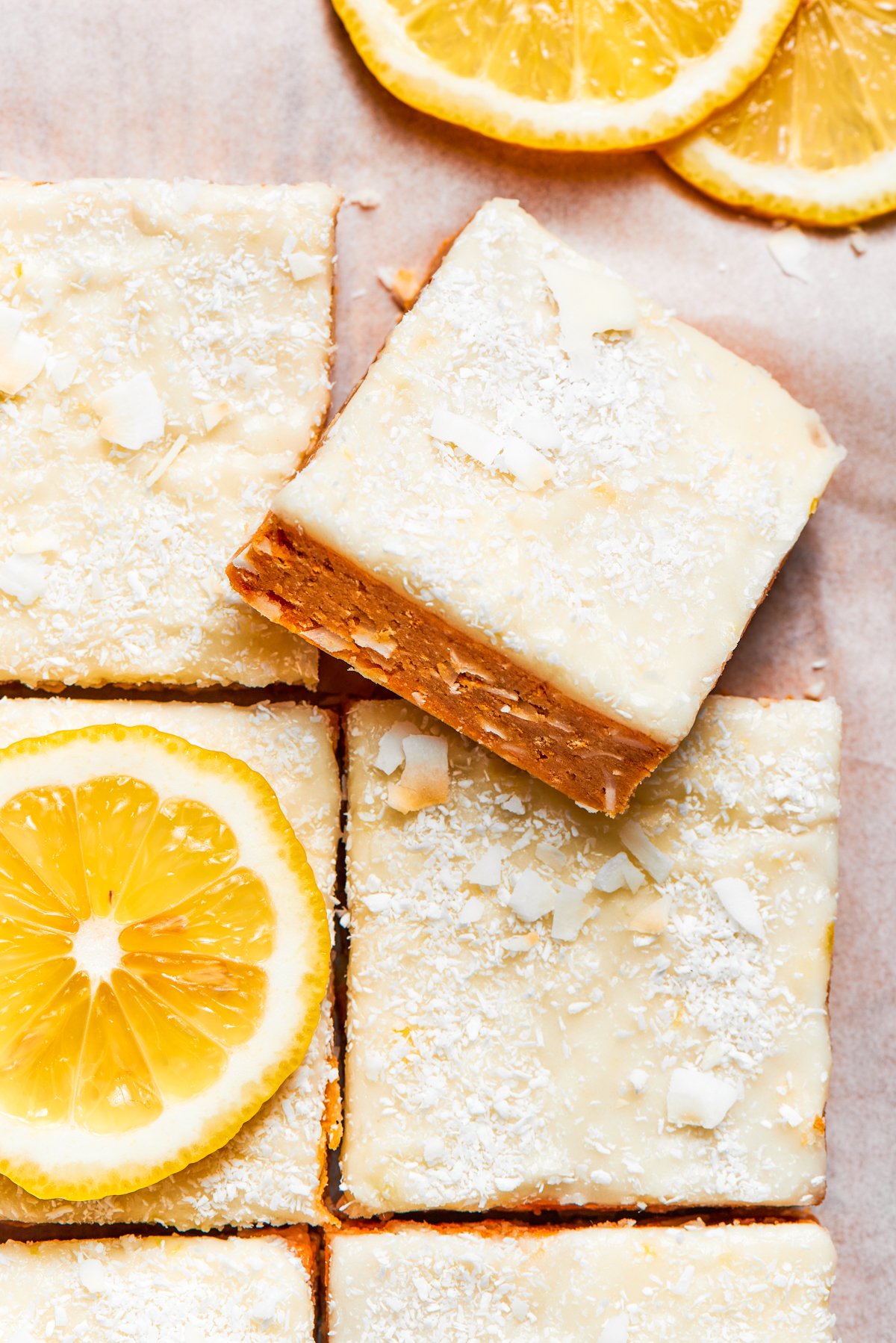 Lemon Slice is an incredibly easy no-bake treat that’s bursting with lemon flavor and only needs a few simple ingredients. A square of lemon slice on top of other lemon slices.