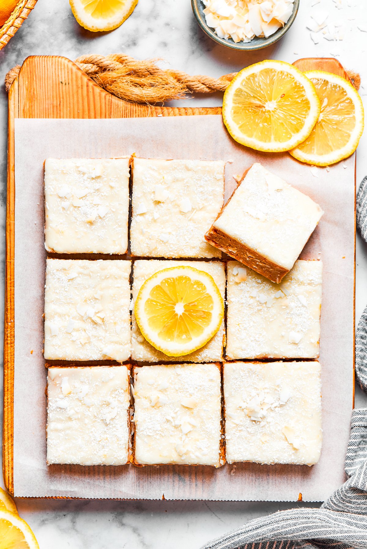 Squares of lemon slice topped with frosting.